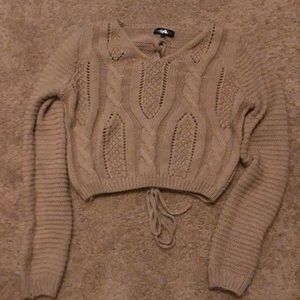 Cropped, tan sweater. Lace up back.